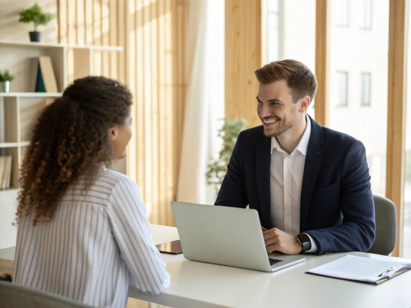 An image of a professional recruiter interviewing a candidate in a modern office setting, emphasizing the agency's focus on talent acquisition.