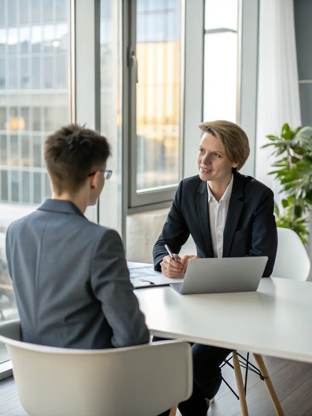 A professional recruiter interviewing a candidate in a modern office setting, emphasizing the agency's commitment to finding the right fit.